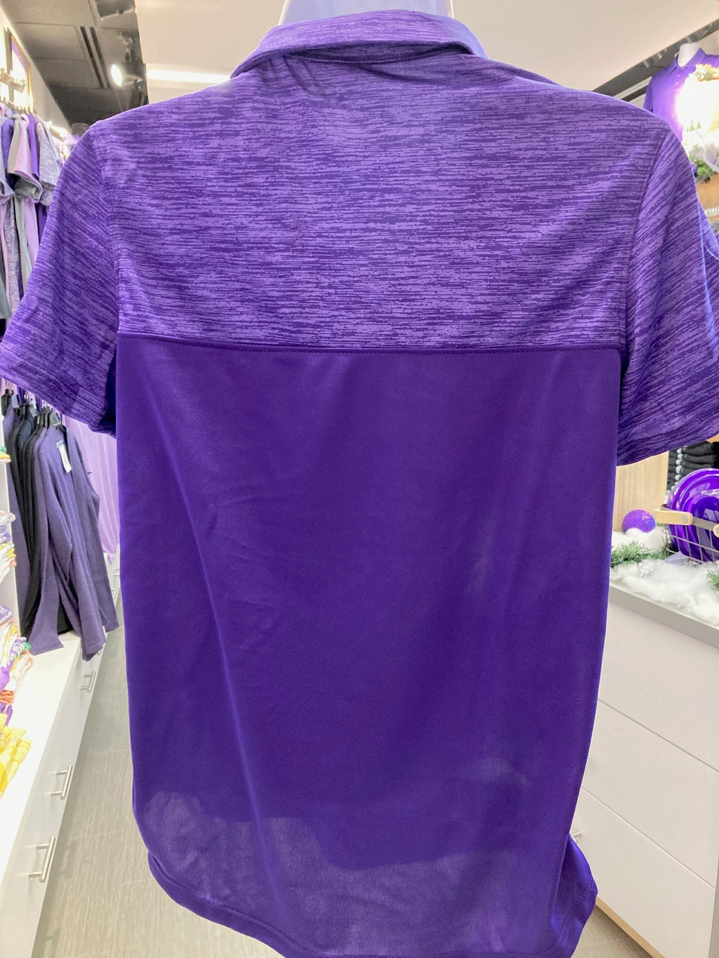 A rear view of the plain purple lady's shadow sport shirt. 