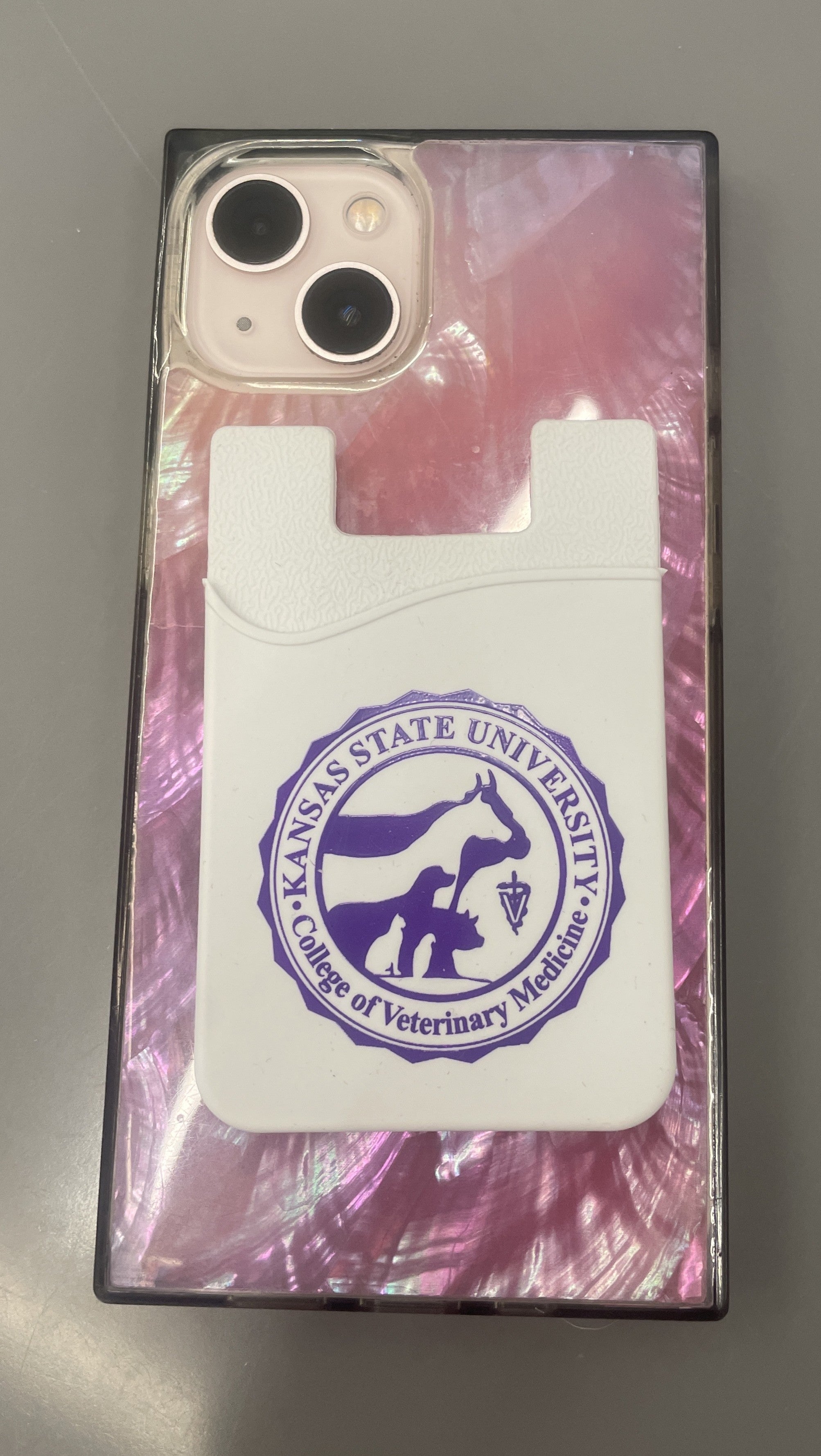 Card holder with Kansas State University College of Veterinary Medicine seal that attaches to the back of your phone. 