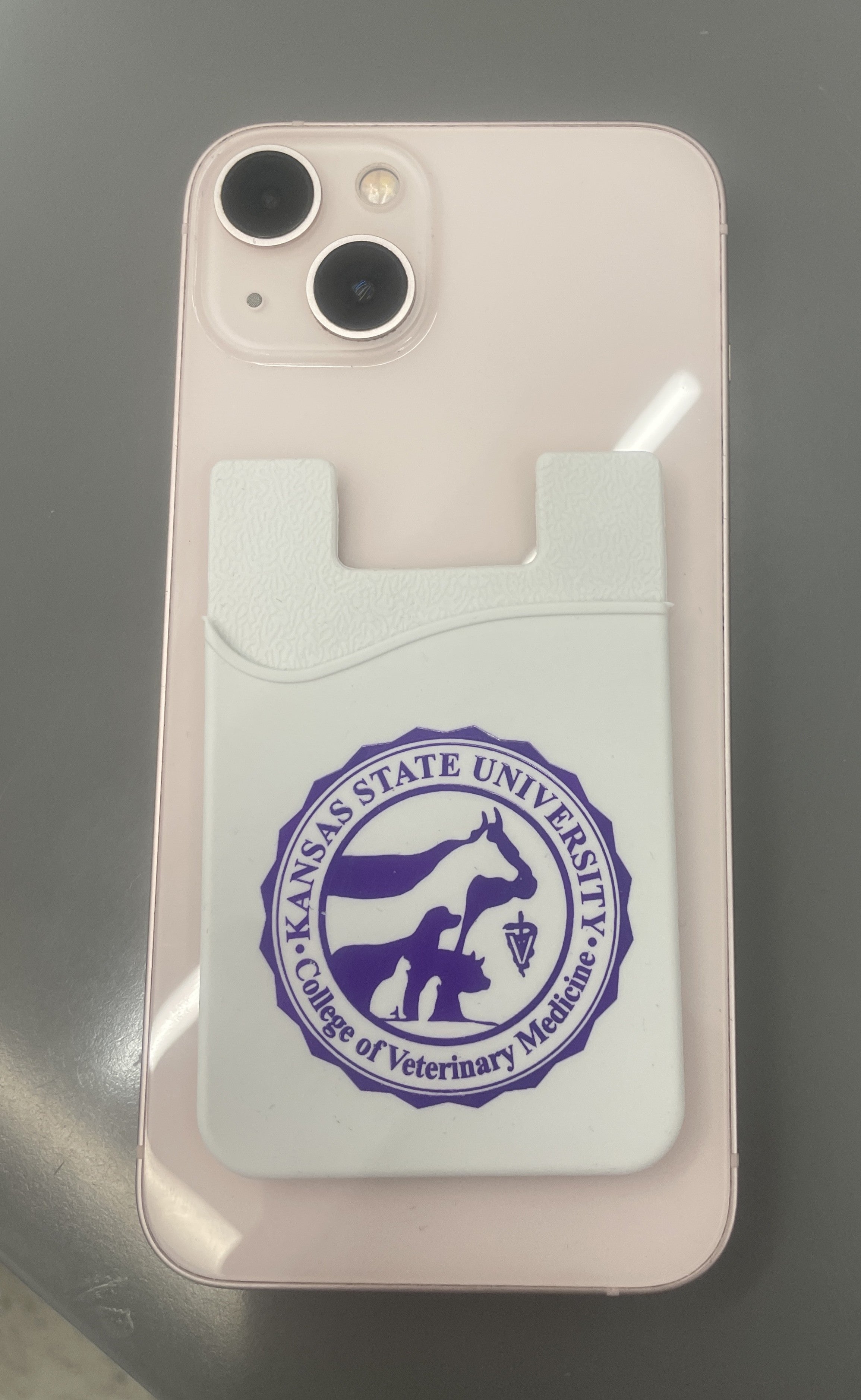 Card holder with Kansas State University College of Veterinary Medicine seal that attaches to the back of your phone. 