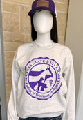 A mannequin wearing a light heather gray sweatshirt with a large purple Kansas State University Veterinary College graphic, paired with dark blue jeans and a purple baseball cap.