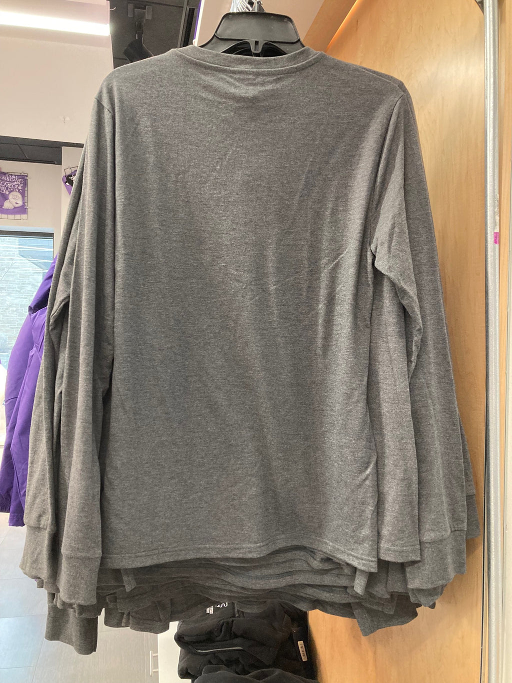 A rear view of the plain gray district long sleeve Henley shirt. 