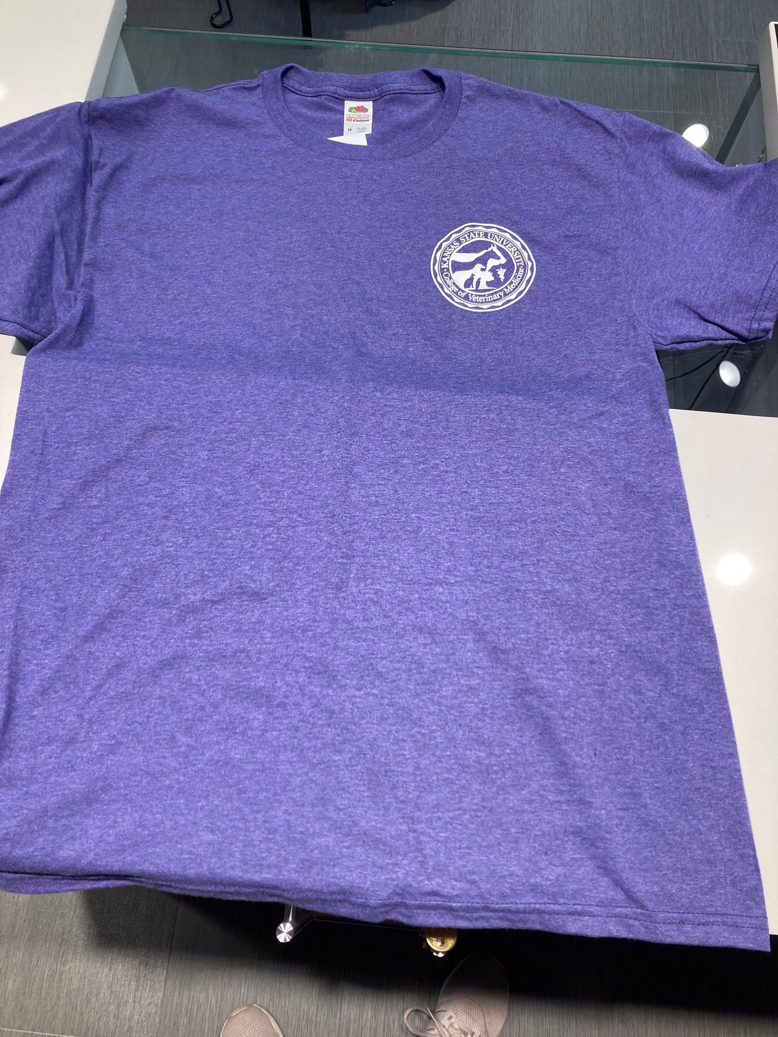 A heather purple t-shirt with a white CVM seal printed on the left chest.