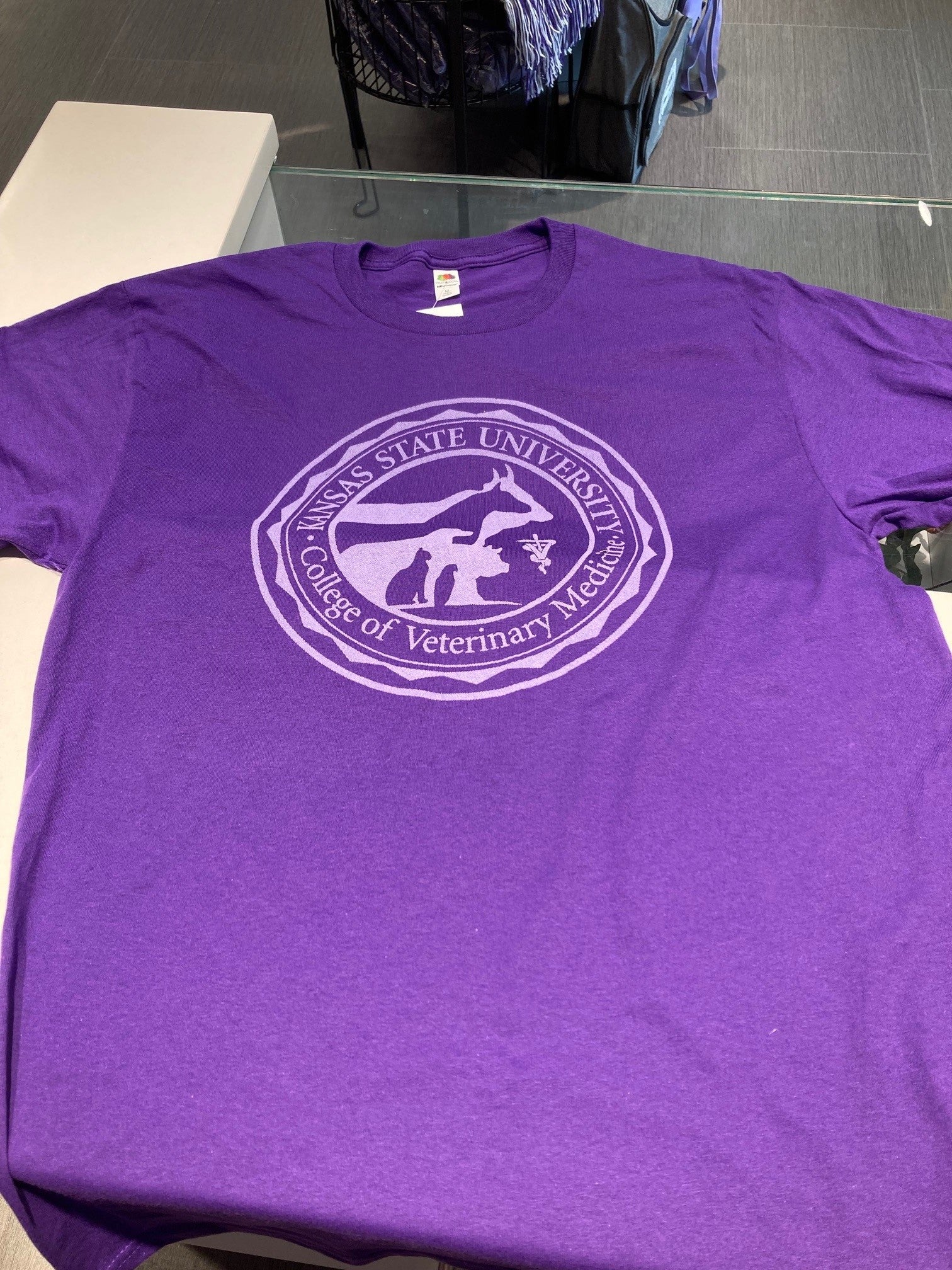 A purple Fruit of the Loom t-shirt with a custom College of Veterinary Medicine seal printed in white.