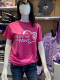 A pink Fruit of the Loom cotton T-shirt with a Valentine's Day theme displayed on a mannequin. The shirt has text that reads "My Valentine Has Paws" and a CVM seal graphic.