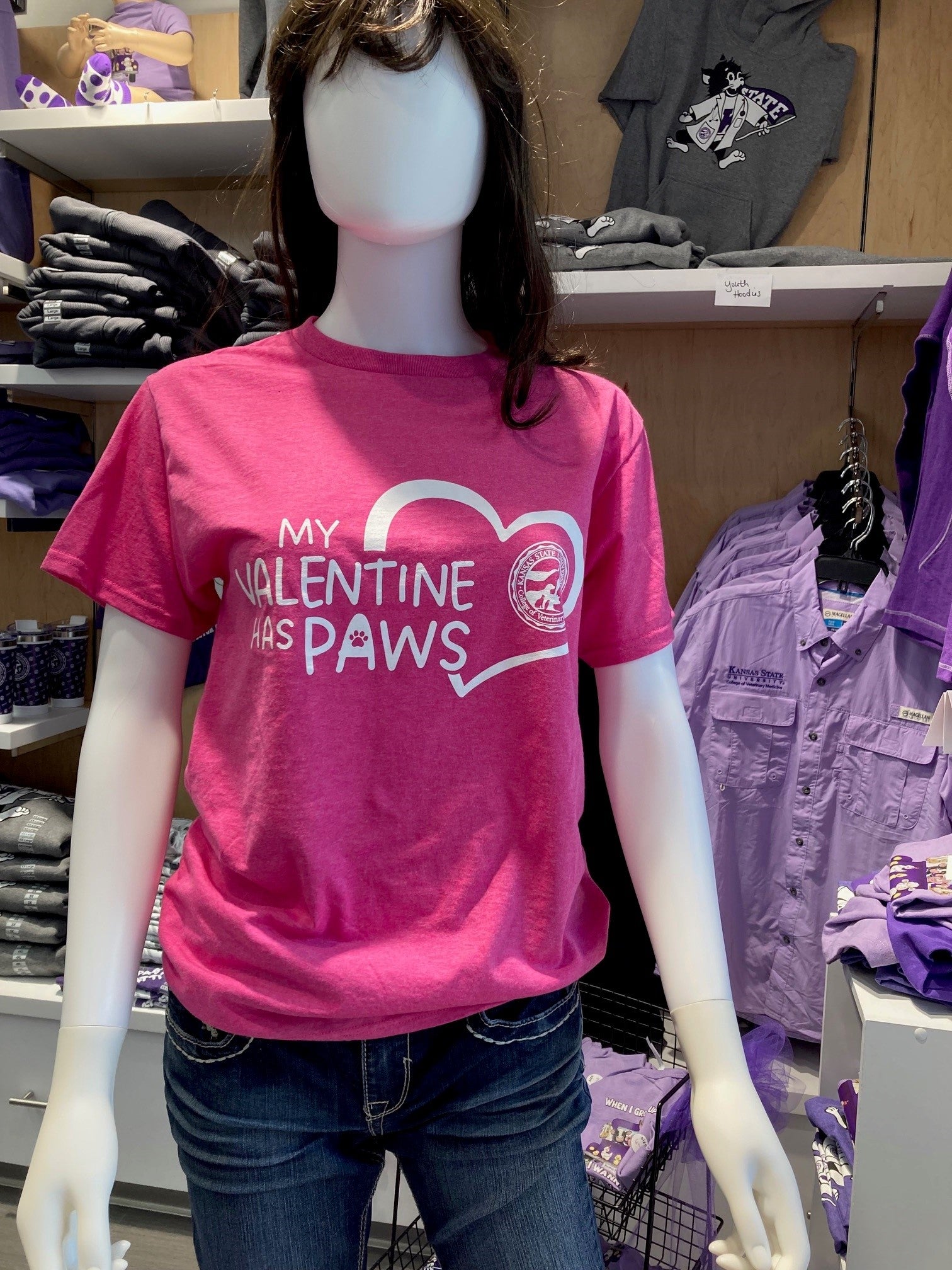 A pink Fruit of the Loom cotton T-shirt with a Valentine's Day theme displayed on a mannequin. The shirt has text that reads "My Valentine Has Paws" and a CVM seal graphic.