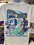 A white Gildan t-shirt with full color back print featuring the College of Veterinary Medicine, including a statue and a Labcoat Willie illustration with the words "College of Veterinary Medicine". 