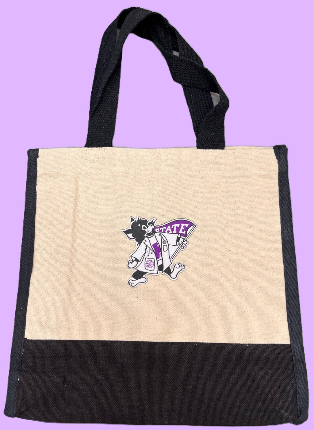Black and beige tote bag with the iron-on logo of Labcoat Willie on a purple background.