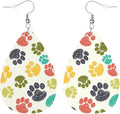 A pair of beige leather earrings with multicolored paw print patterns.