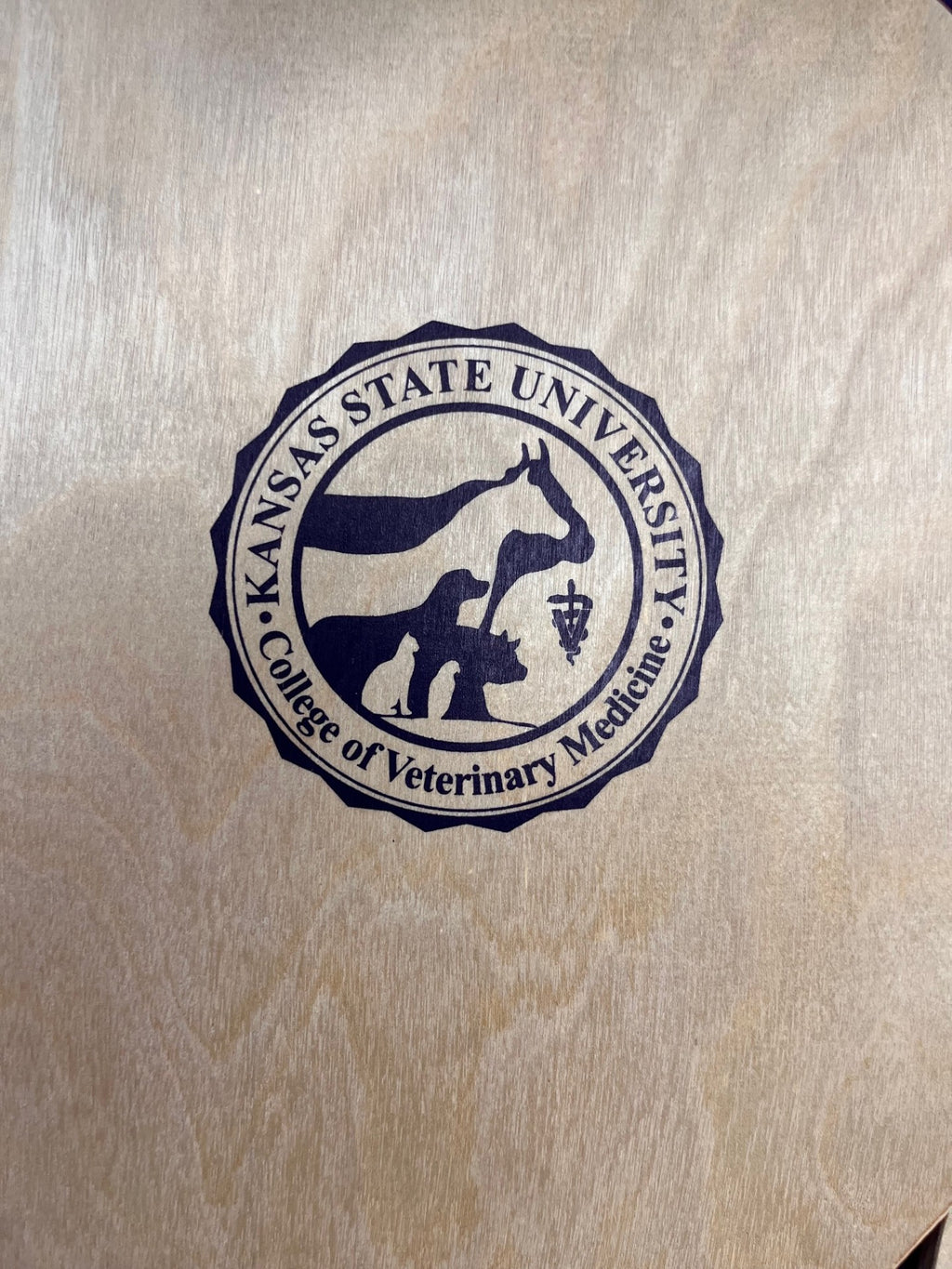 The paddles have a dark purple CVM seal in the center. 