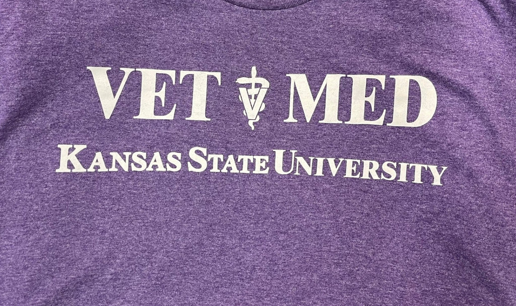 Purple shirt with 'VET MED Kansas State University' white text. 