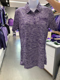 A purple and white dashed/striped patterned Sport-Tek ladies posicharge polo shirt displayed on a mannequin in a retail environment. There is a dark purple embroidered K-State CVM logo on the upper left chest area. 