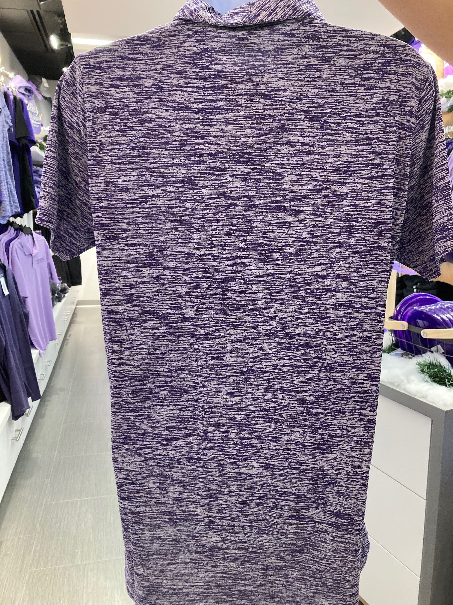 A rear view of the purple and white dashed/stripped polo shirt. 