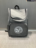 A gray Trek backpack with a front pocket and a white CVM seal. 
