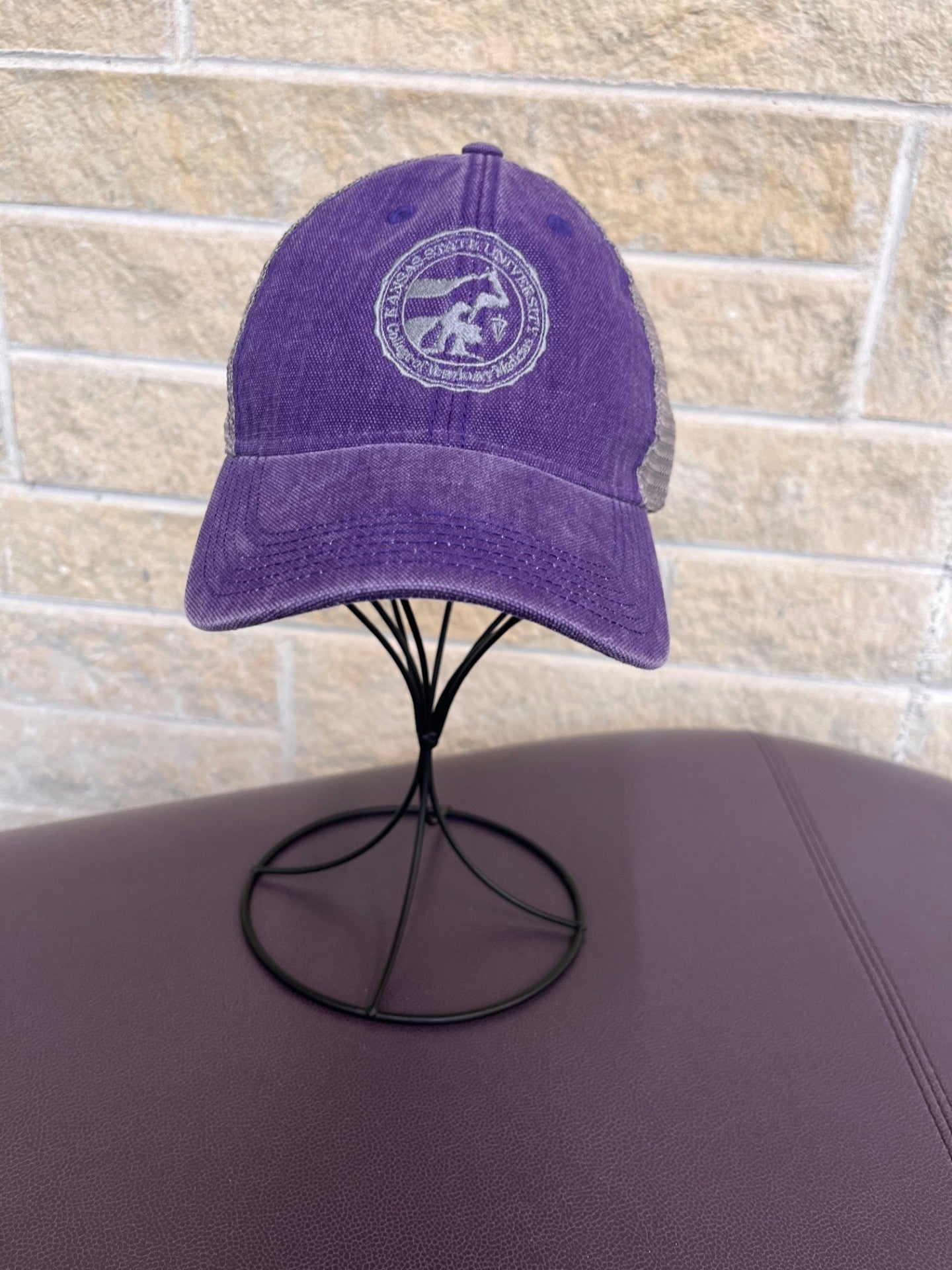 Trucker hat in purple and grey with embroidered CVM seal in grey 