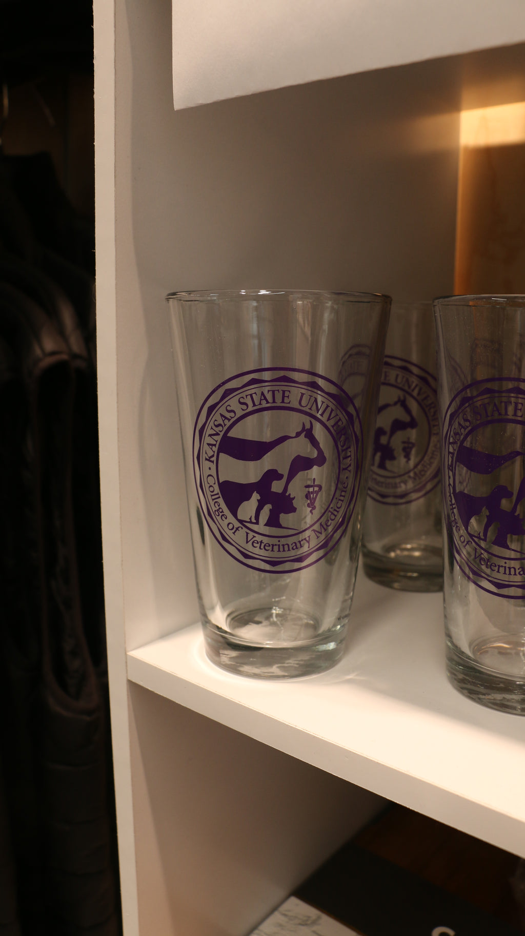 A set of clear executive pint glasses with the purple CVM seal in the center. 