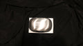 A silver steel soap bar on a black background, packaged in a cardboard box with the CVM logo engraved in the center. 