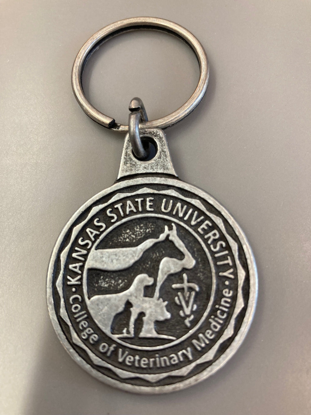 An image a 1 3/8" diameter Antique style silver keychain customized with the College of Veterinary Medicine seal.