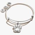 A silver-colored bangle bracelet featuring multiple charms including a paw print.