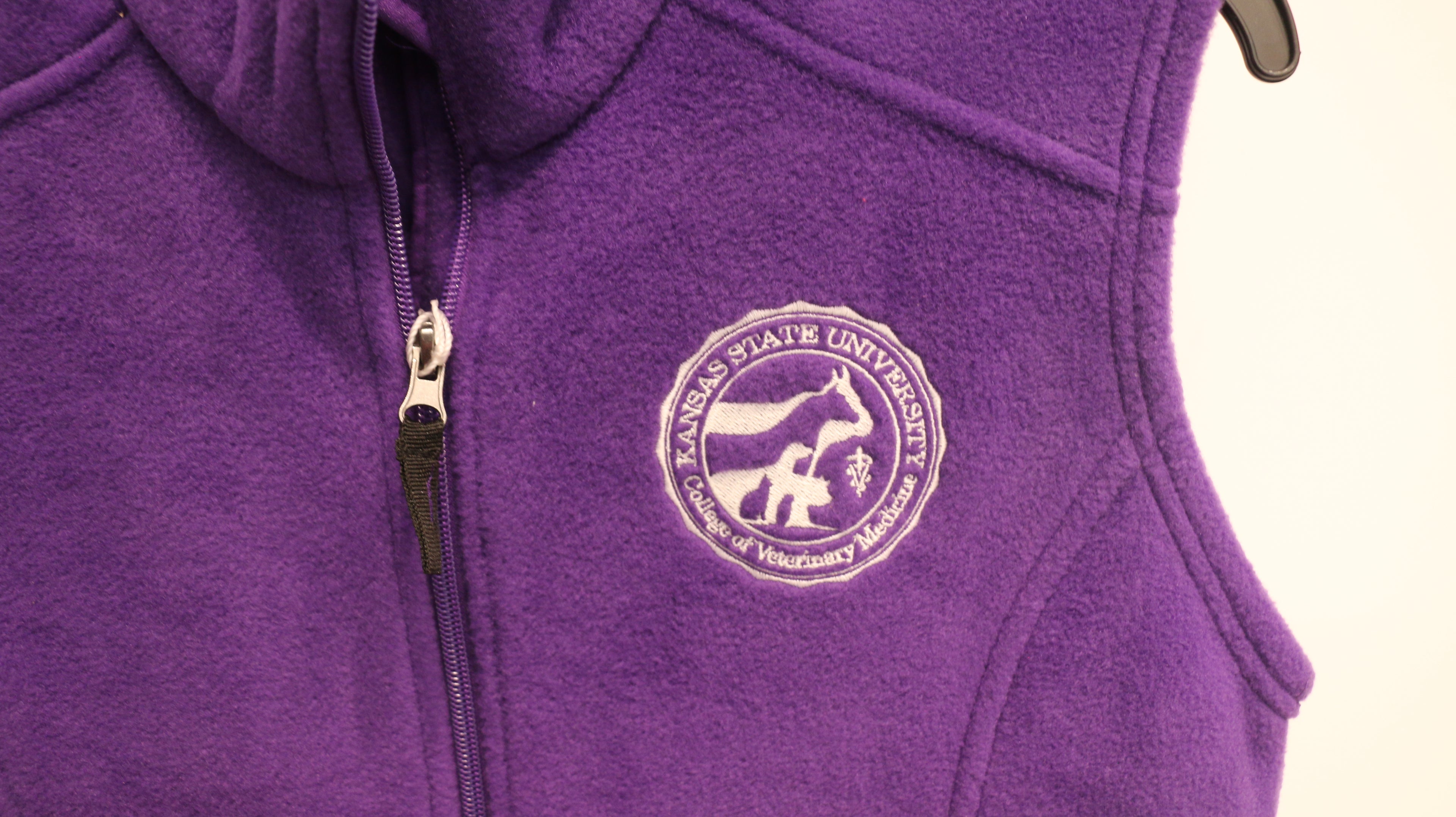 A close-up of the white CVM seal on the upper left chest area. 