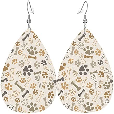 A pair of beige, brown, and black leather earrings with small paws and bones making up the pattern. 