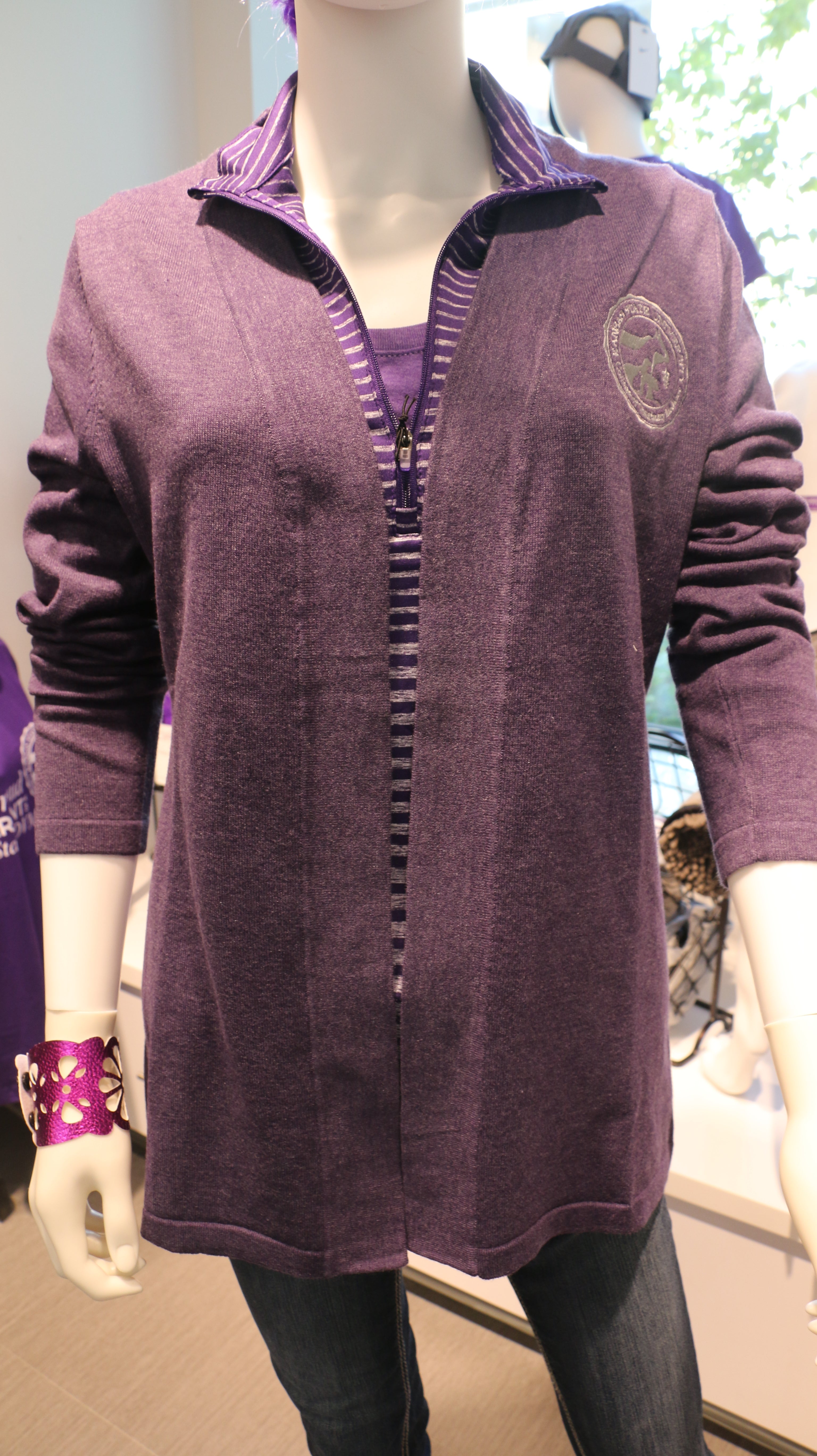 A purple heathered Edwards cardigan sweater displayed on a mannequin with the CVM seal on the upper left chest. 