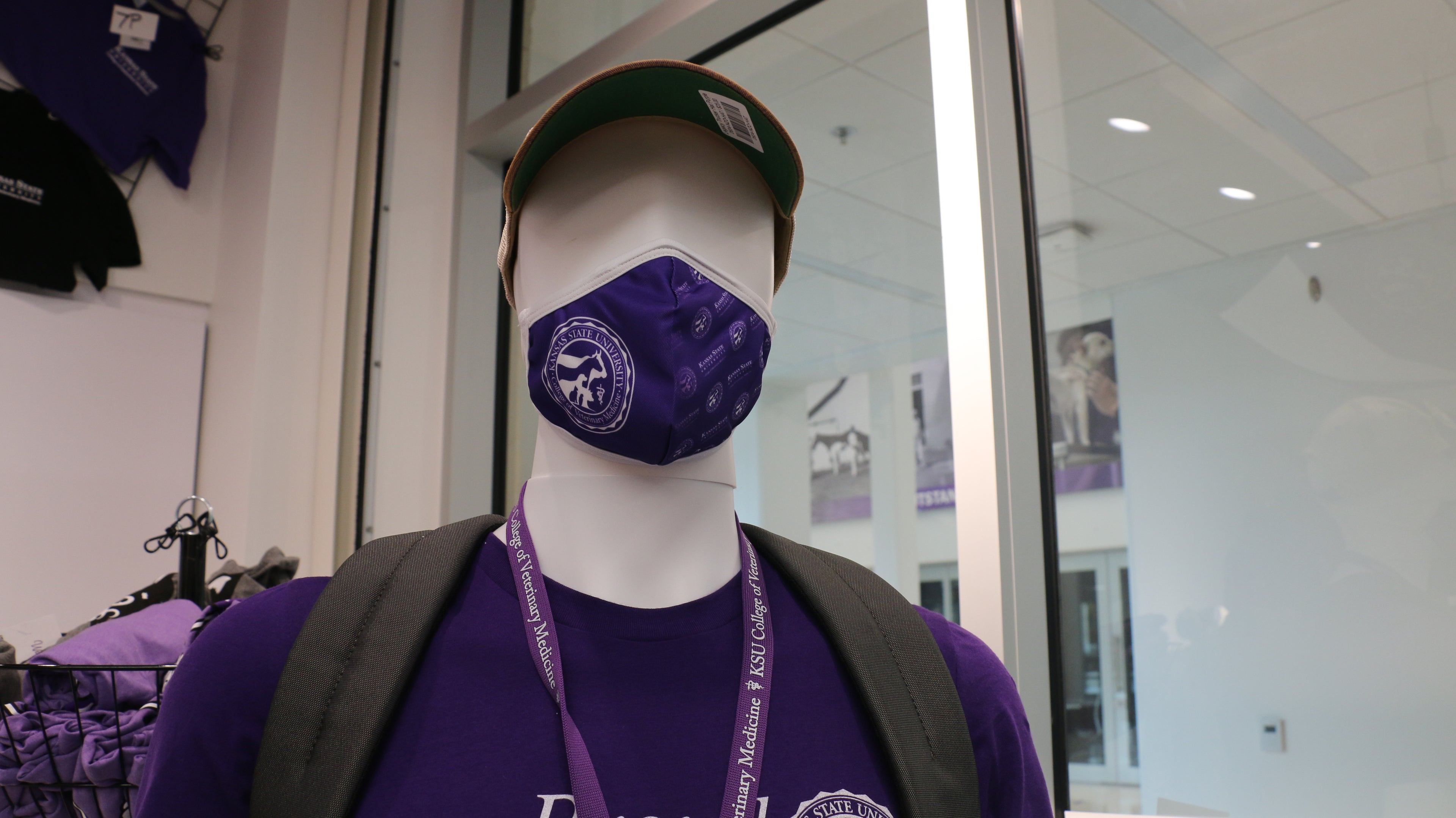 A purple face mask displayed on a mannequin head, featuring a 3-layer design with a filter pocket, nose clip, and an adjustable elastic band.
