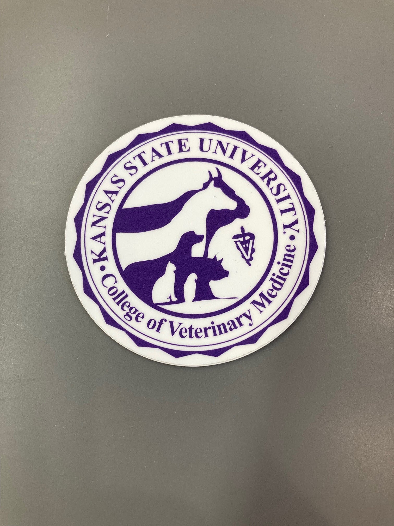 A 3-inch round sticker featuring the K-State College of Veterinary Medicine logo with a purple and white color scheme.