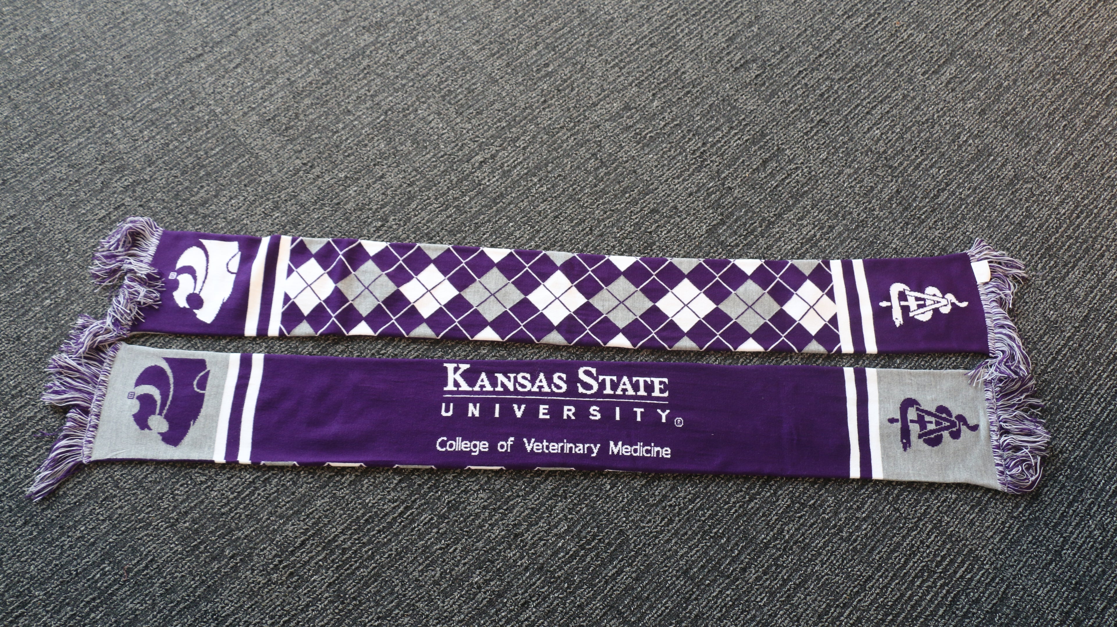 A purple knit scarf with white and purple geometric patterns, K-State CVM logo.