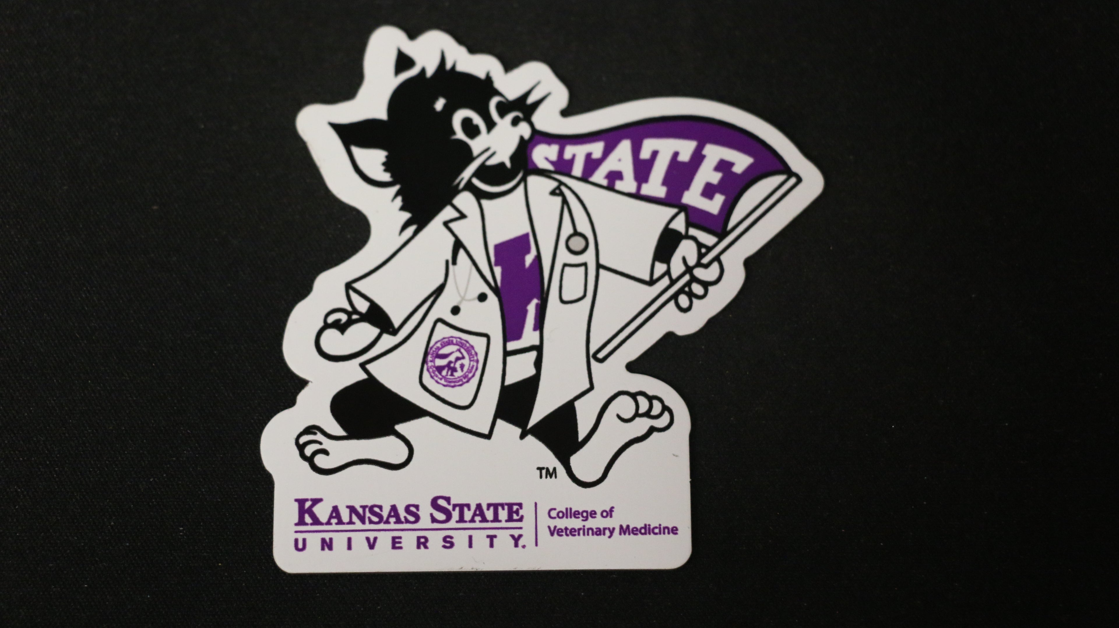 A magnet with an illustration of Labcoat Willie with 'Kansas State University' text on it.