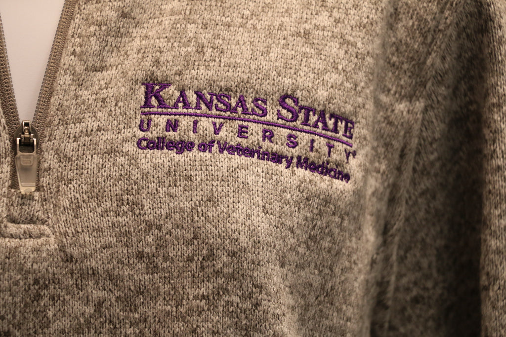 A close-up view of the white CVM logo on the left chest area.