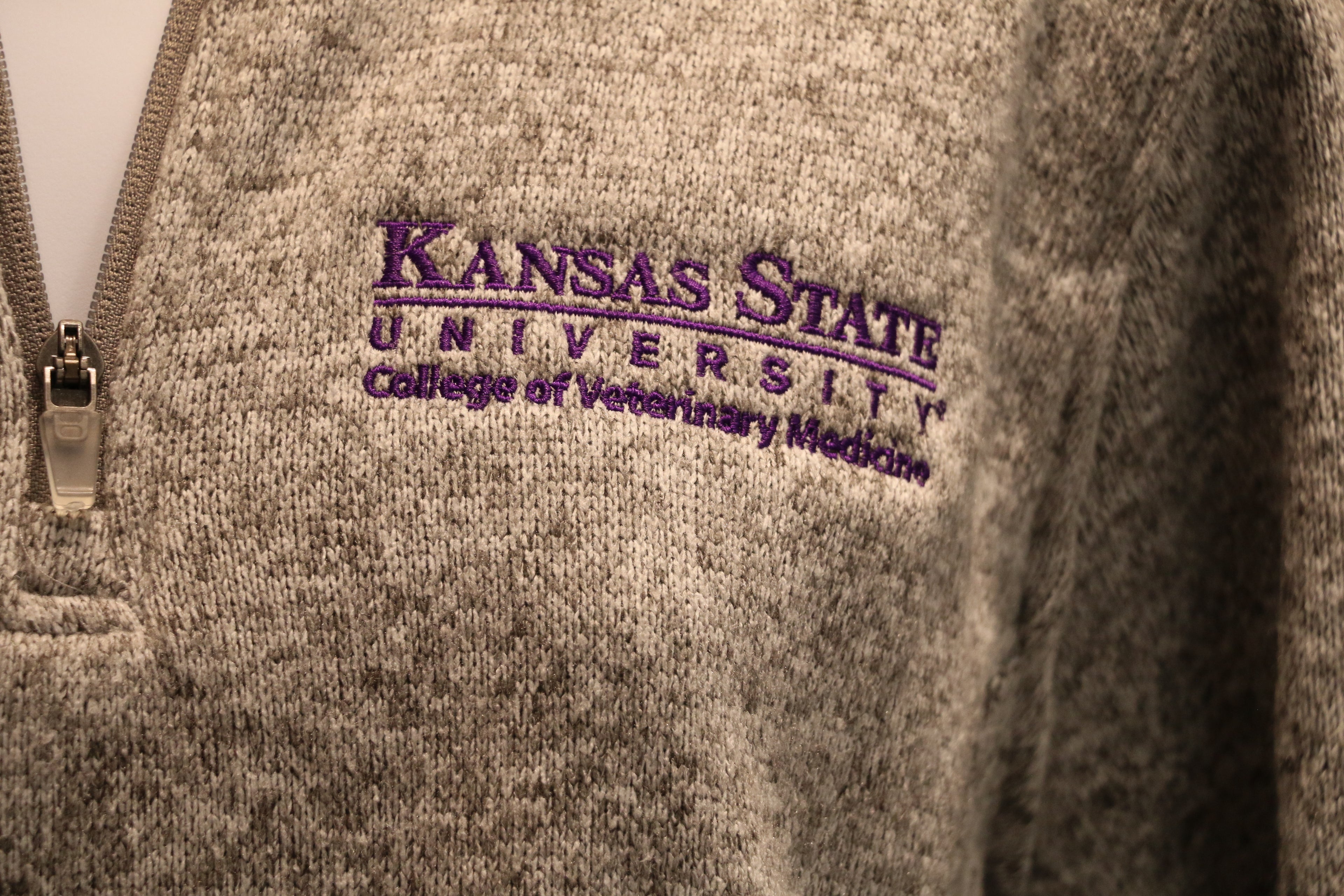 A close-up view of the white CVM logo on the left chest area.