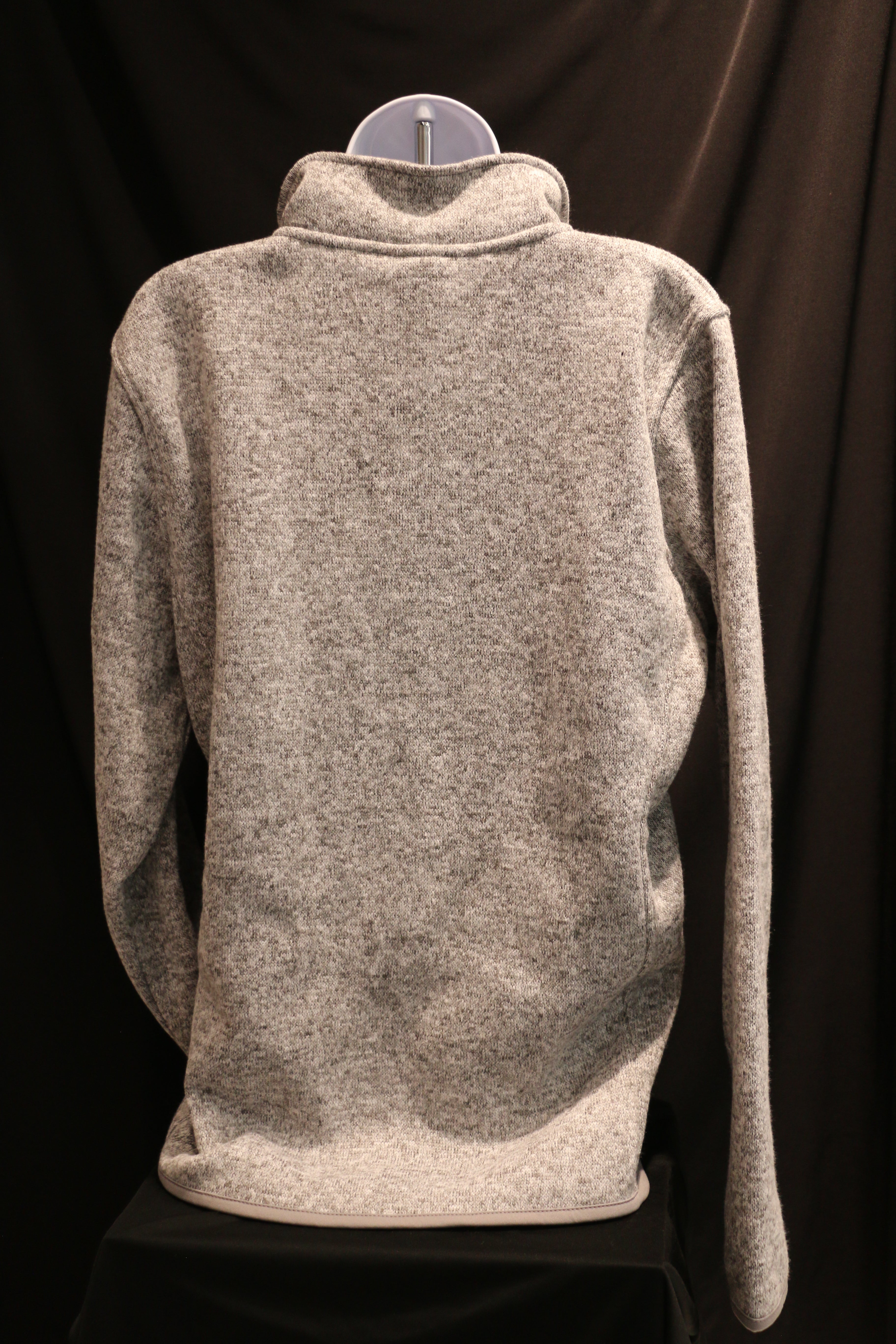 A rear view of the heathered grey ladies quarter zip sweatshirt.