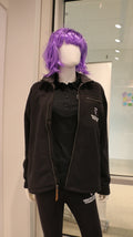 A mannequin wearing a zip up black fleece jacket with quilted details and sherpa lining.