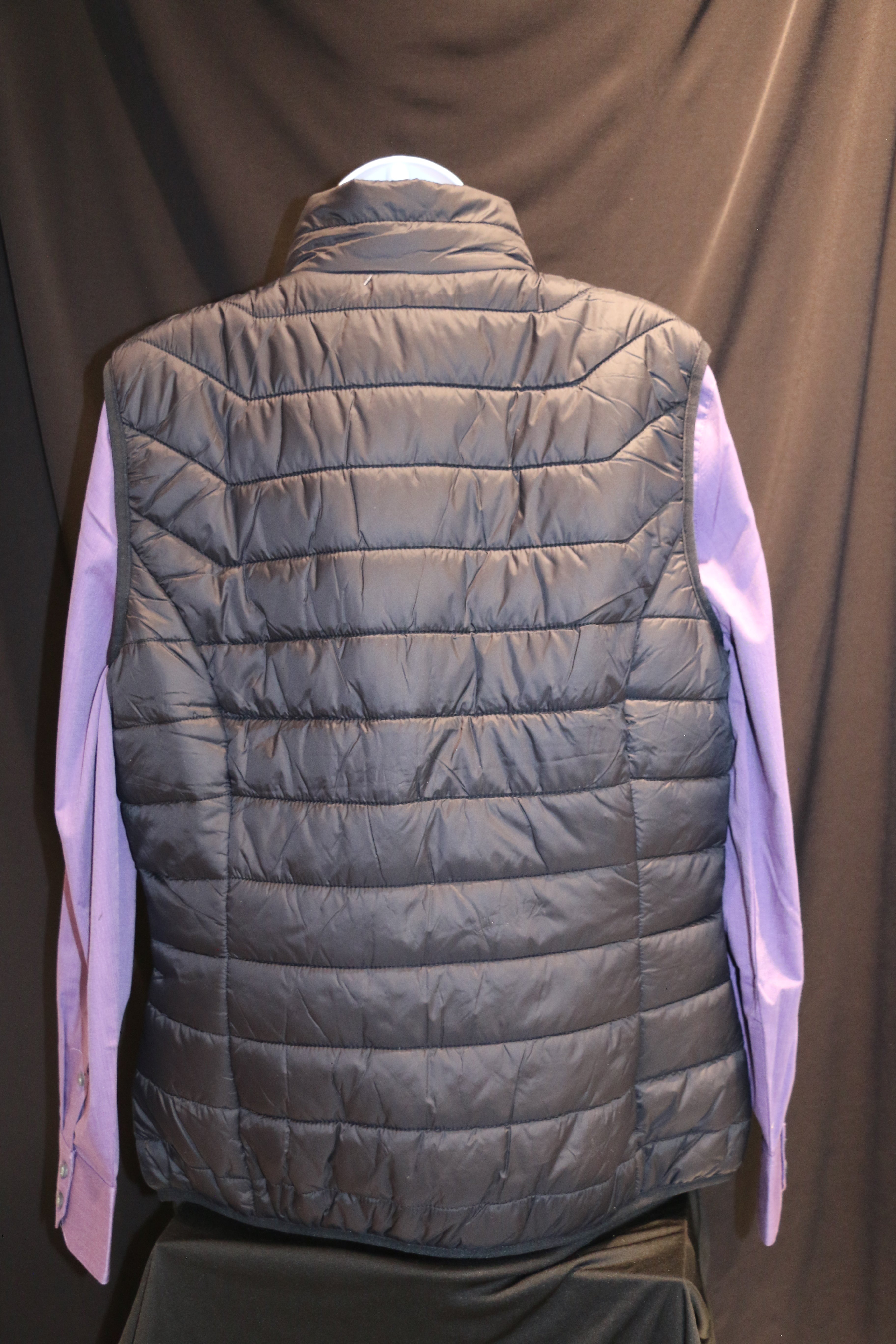 A rear view of black Landway puffer vest. 