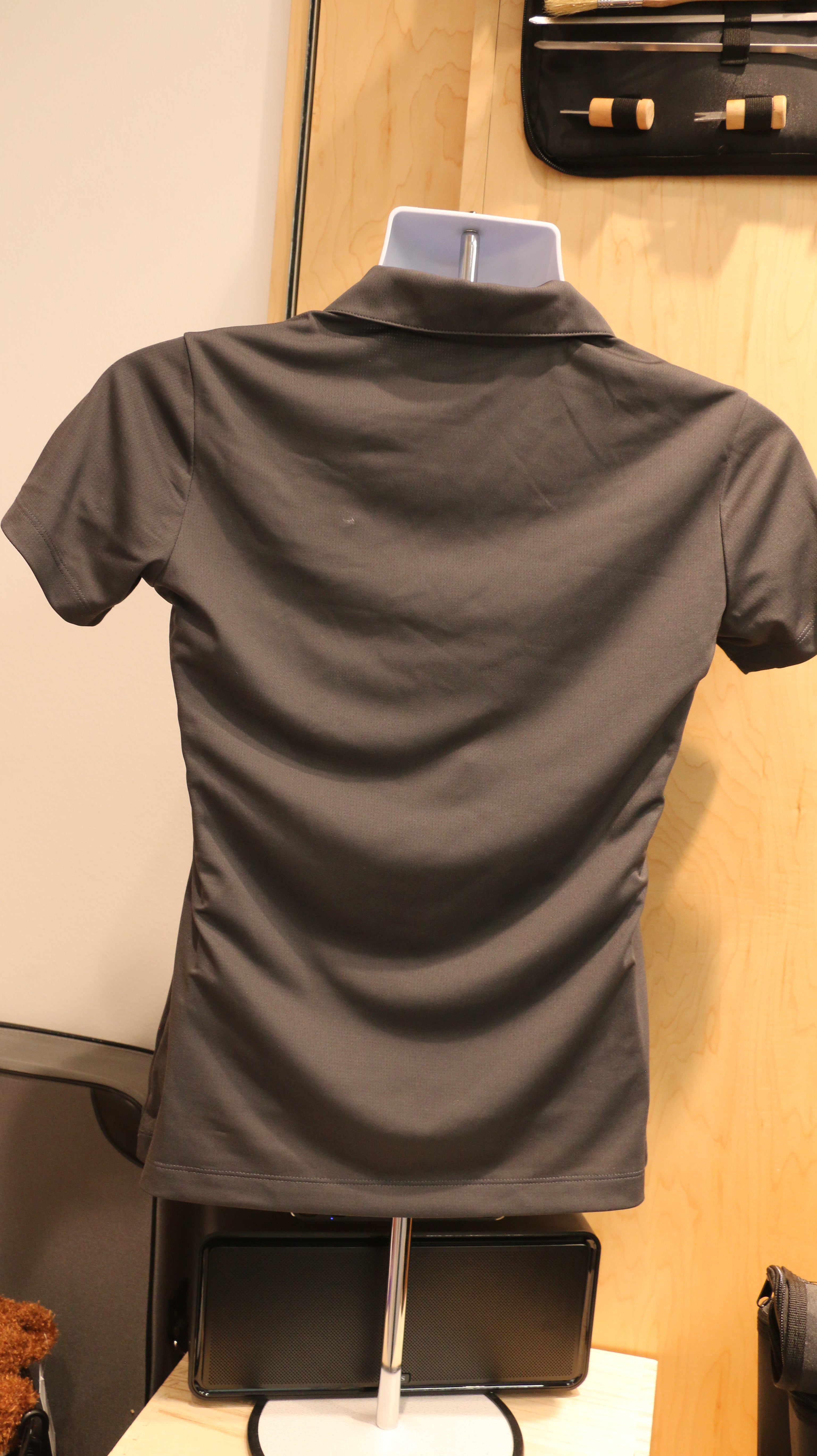 A rear view of the gray Ladies Nike Golf Dri-Fit Mesh Polo.