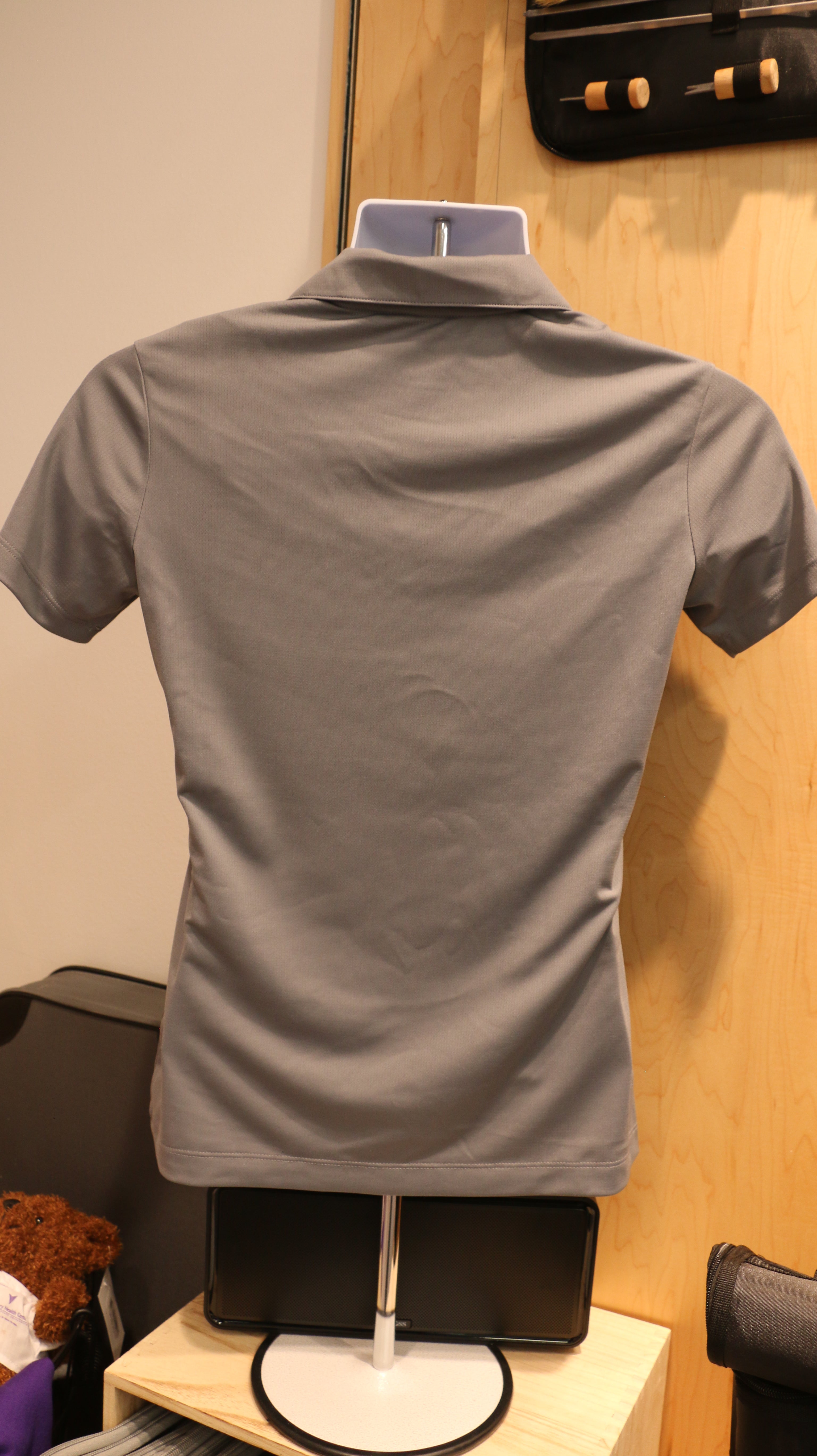 A rear view of the light gray Ladies Nike Golf Dri-Fit Mesh Polo.