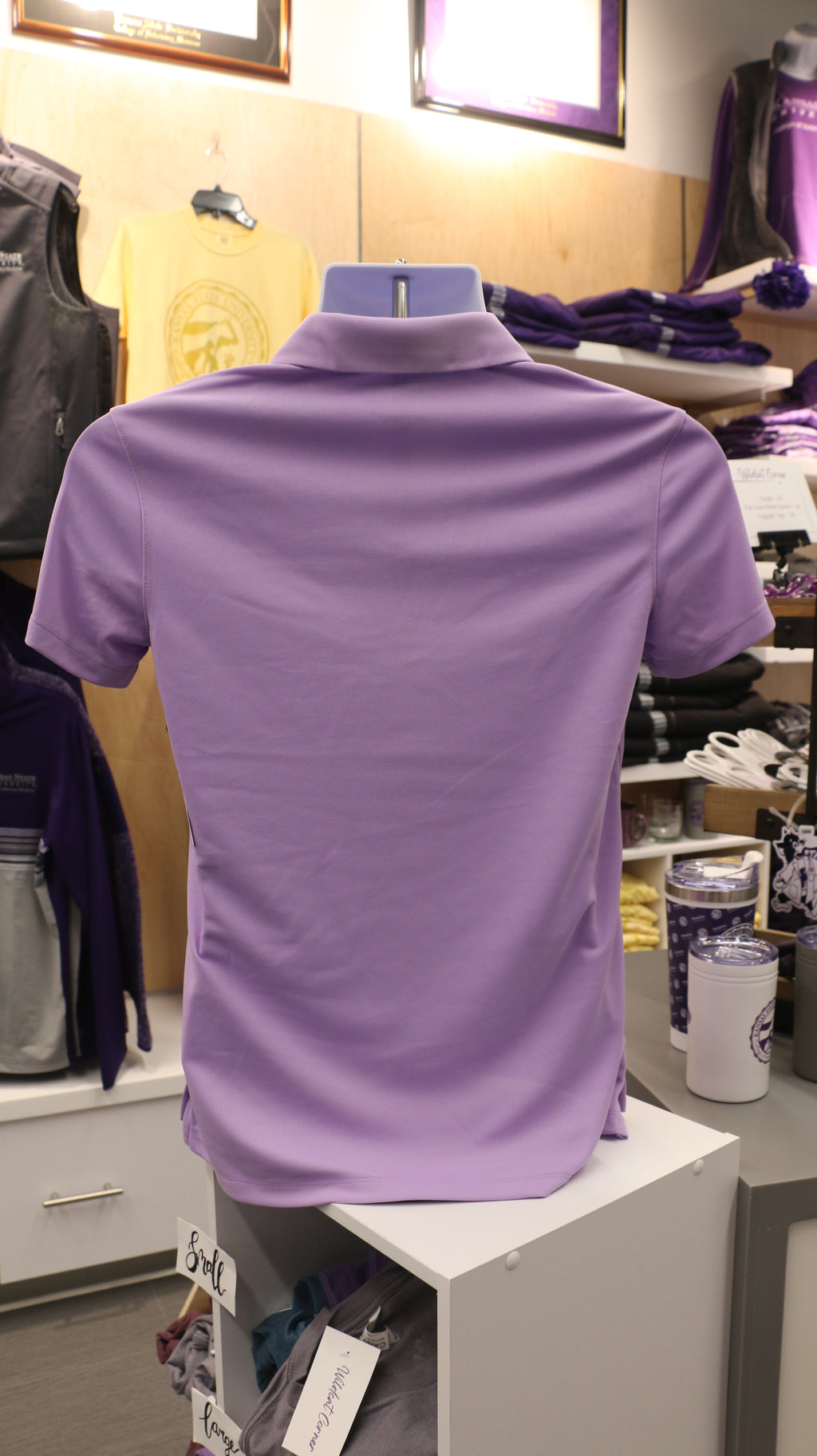 A rear view of the lavender-colored Nike ladies polo shirt.