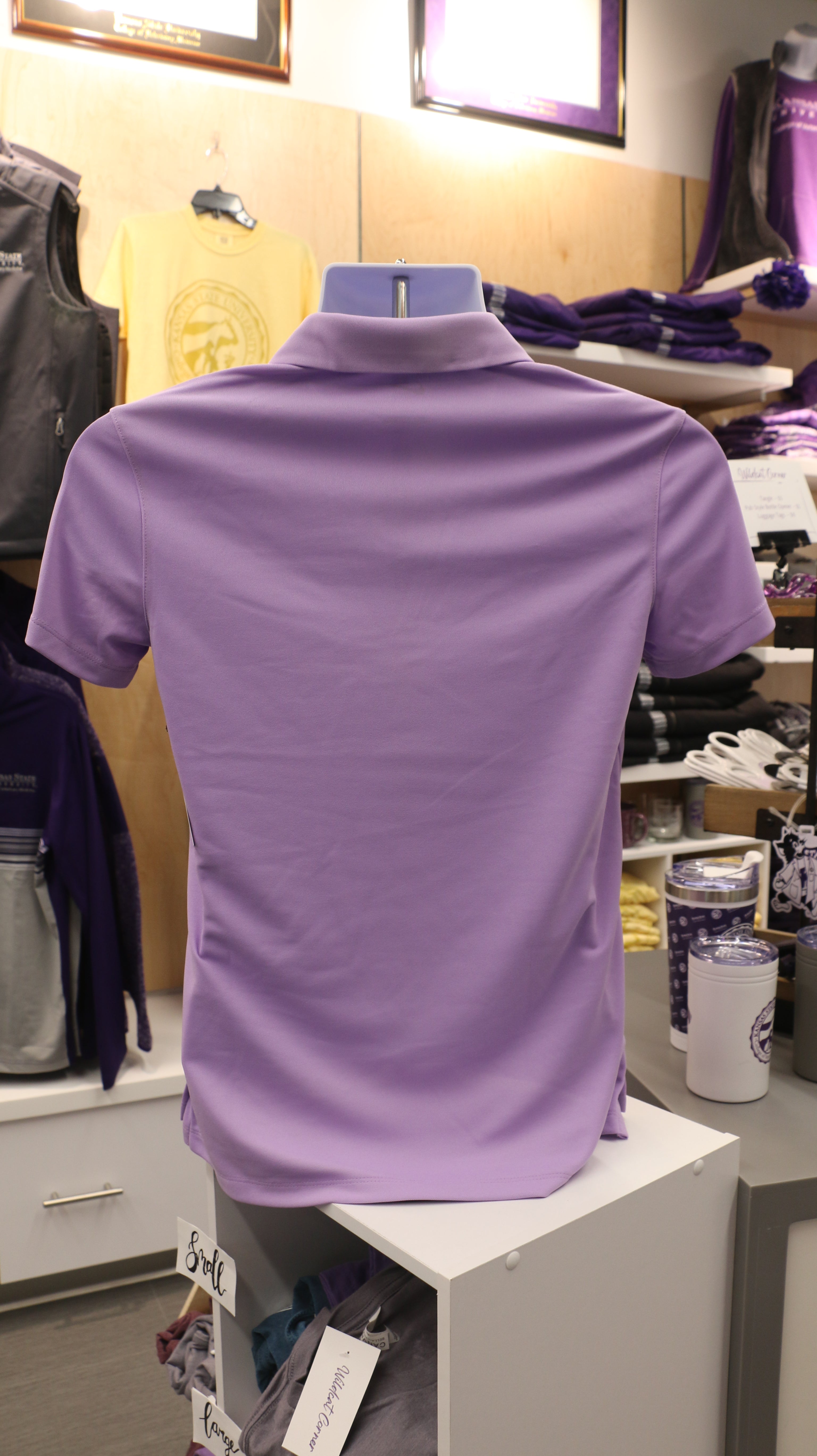 A rear view of the lavender-colored Nike ladies polo shirt.