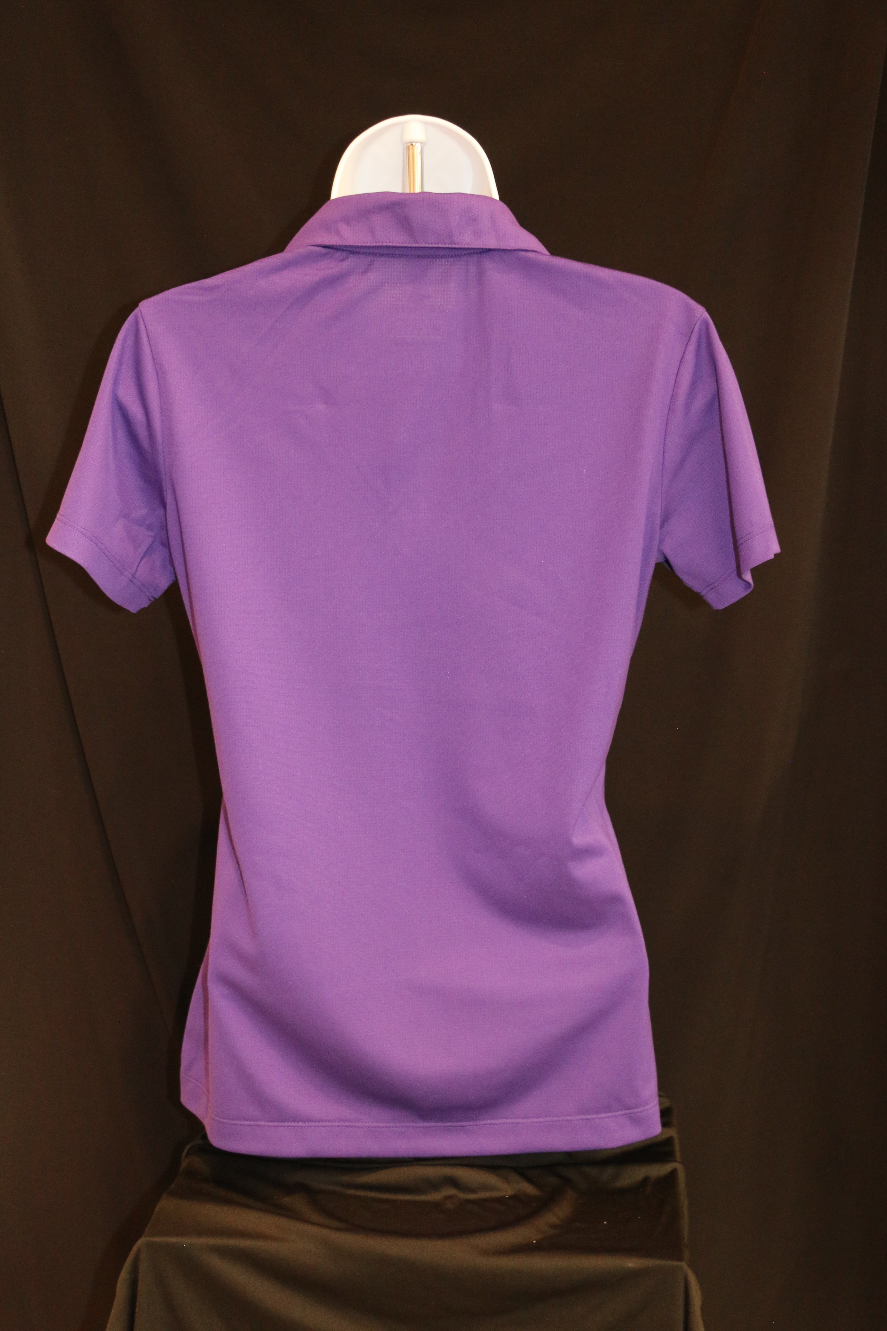 A rear view of the ladies purple Nike polo shirt. 