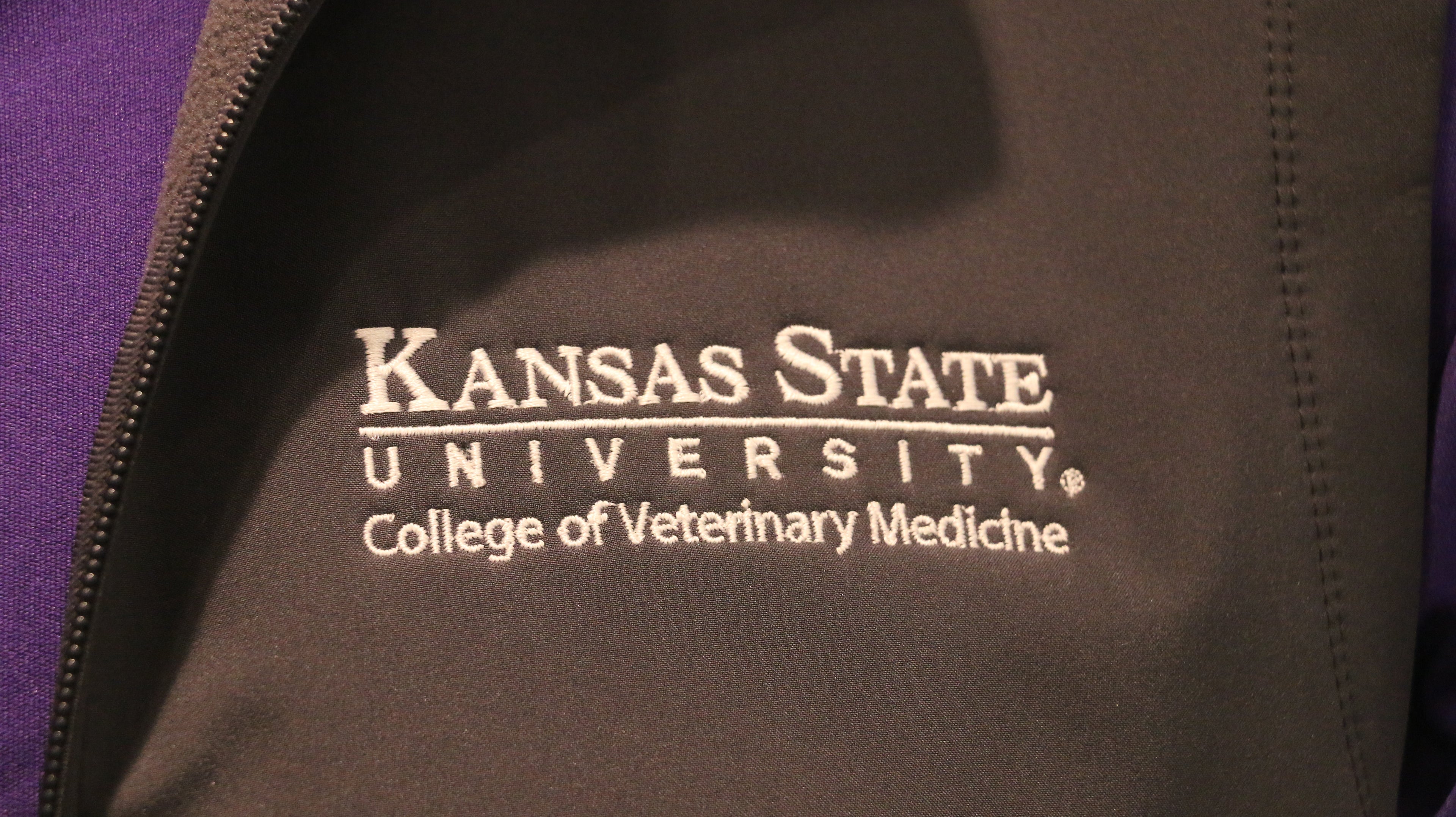 A close-up of the white CVM logo on the upper left chest area. 