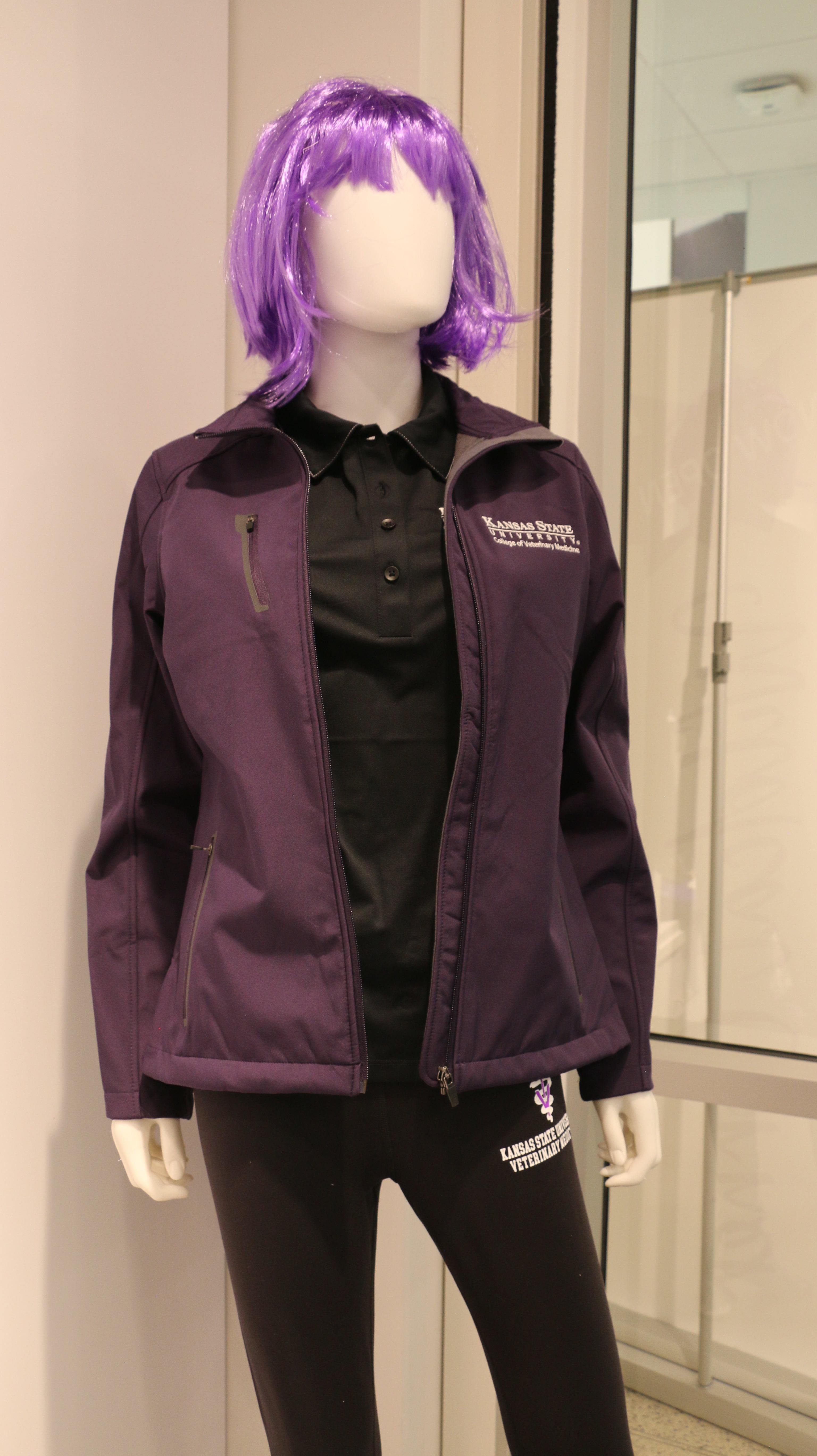 A purple Port Authority soft shell zip up jacket with side zip pockets, white CVM logo, and displayed on a mannequin.