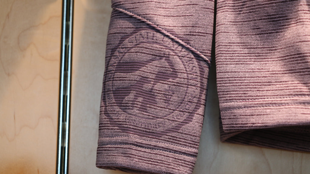 A close-up view of the laser etched college seal on the right cuff.