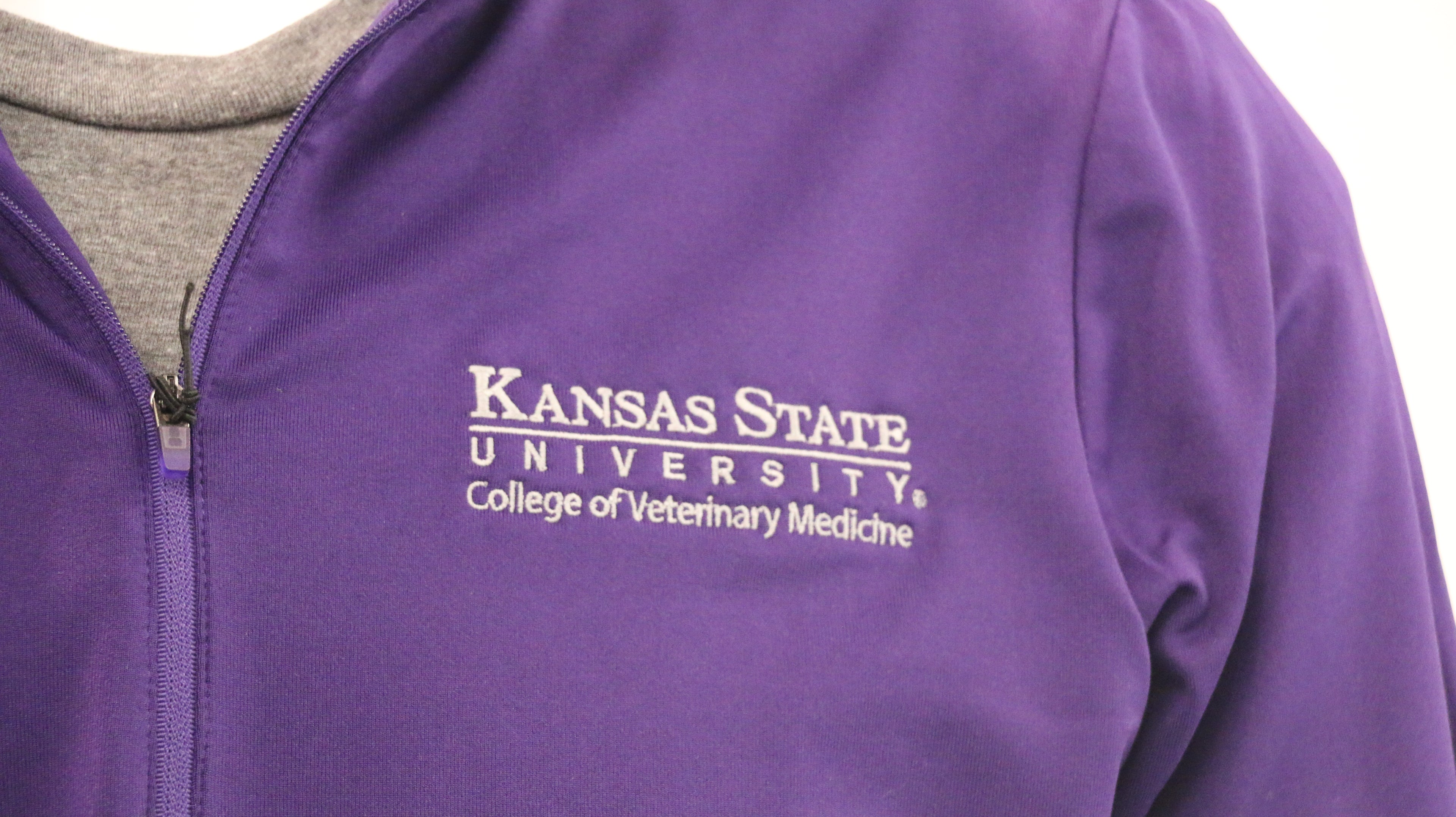 A close-up view of the white K-State CVM logo on the upper left chest area. 