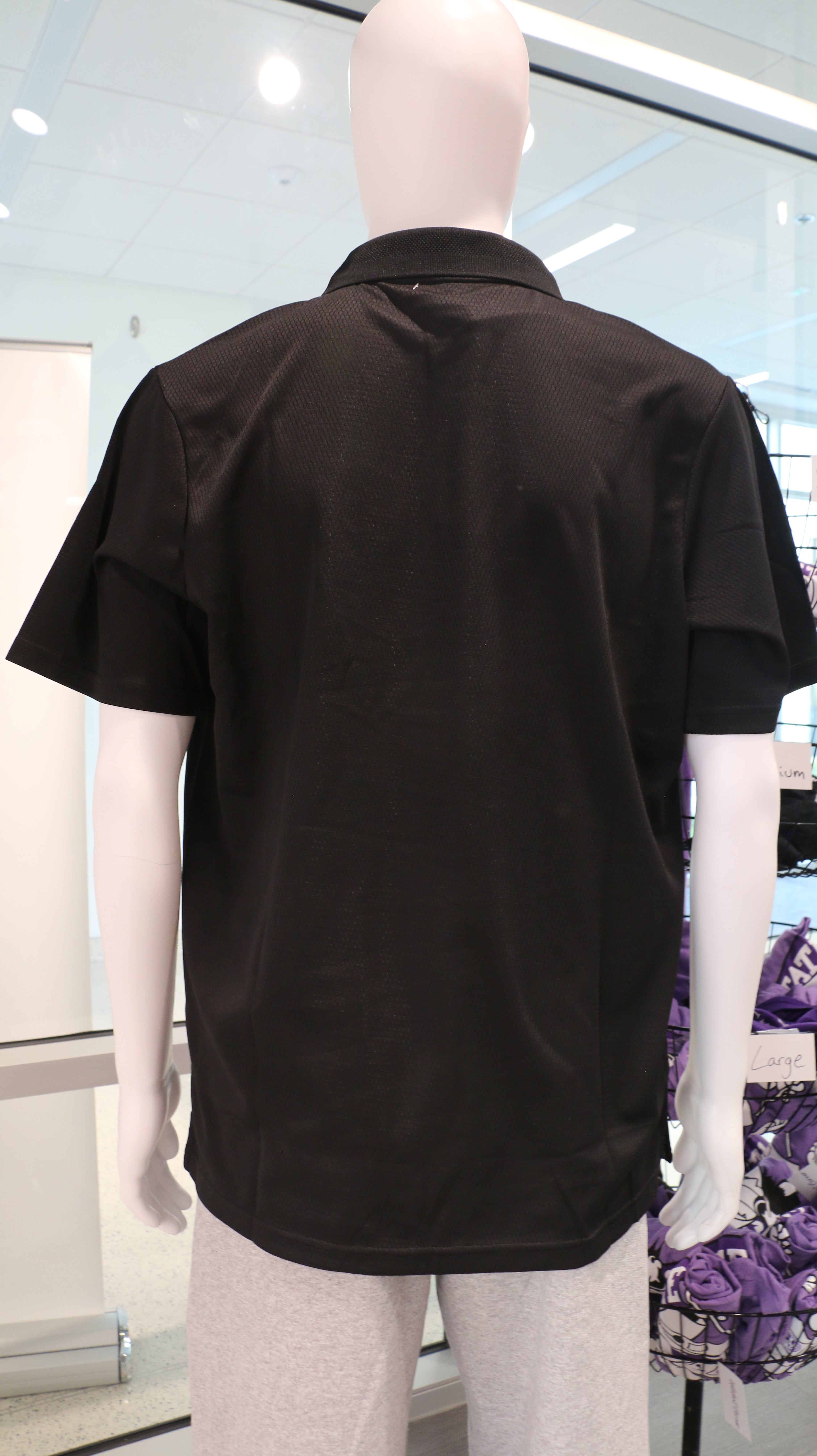 A rear view of the black men's Holloway Prism polo collared shirt. 