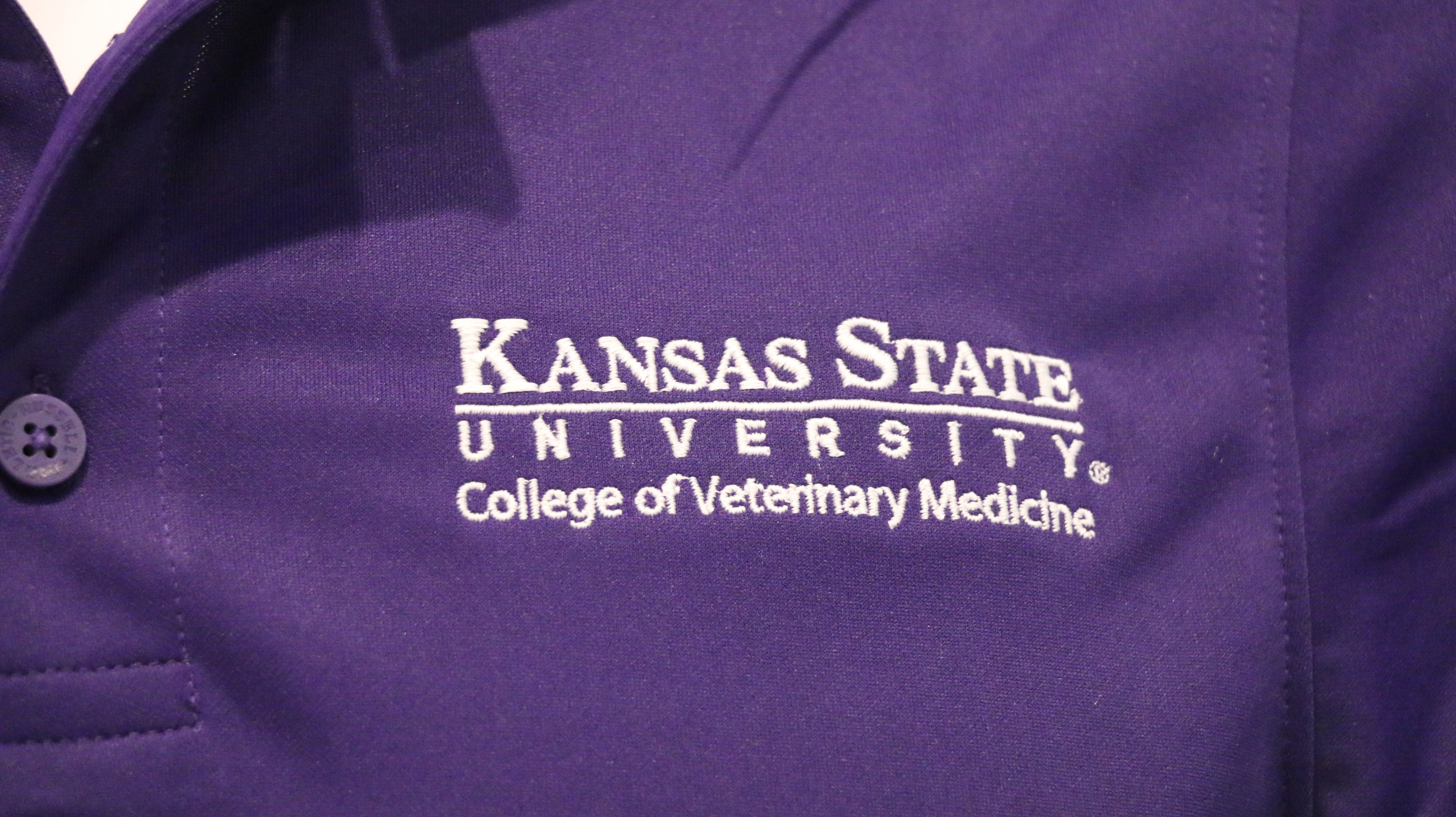 A close-up view of the white CVM logo on the upper left chest area. 