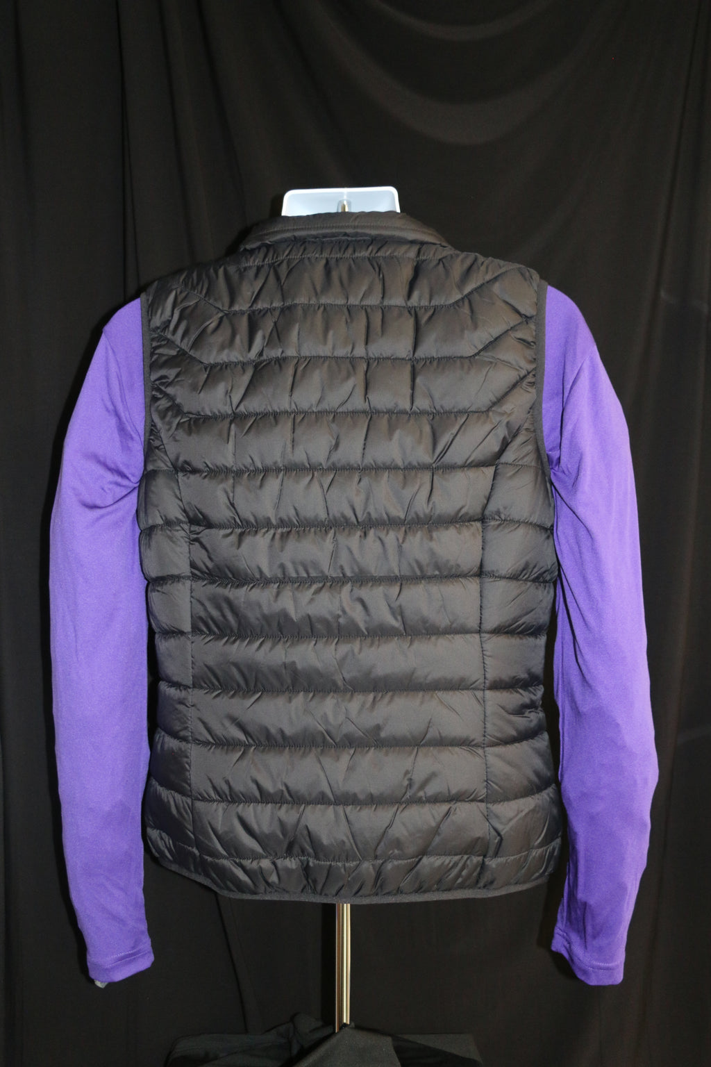 A rear view of the black Men's Landway Puffer Vest. 