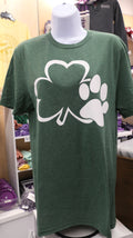 Green t-shirt with a white graphic design of a clover and a paw print on it, displayed on a mannequin.
