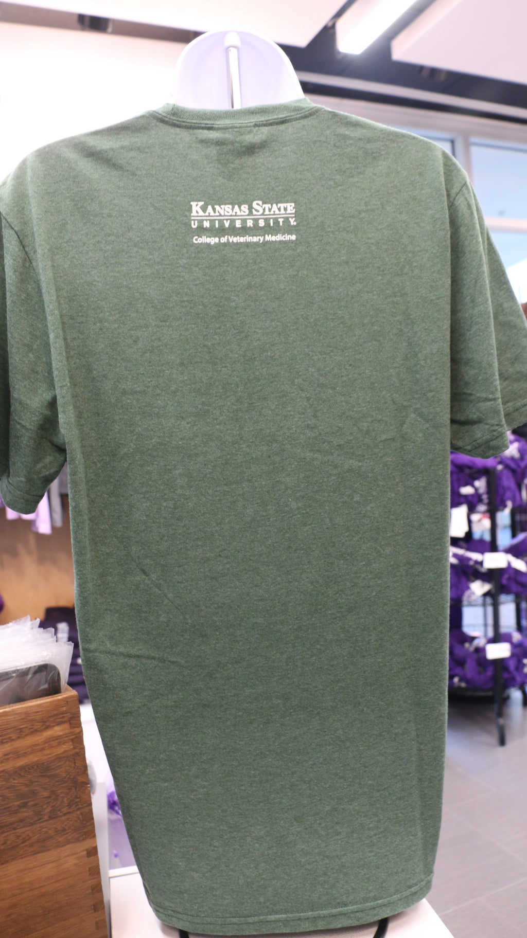 A rear view of the green t-short with a white K-State CVM logo in the upper middle back area. 