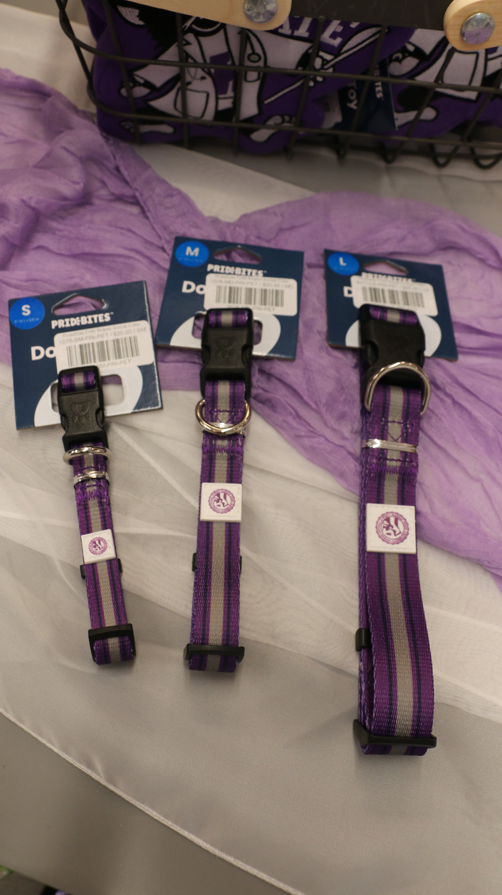 A set of 3 different sized striped purple and grey collars with the CVM seal. 