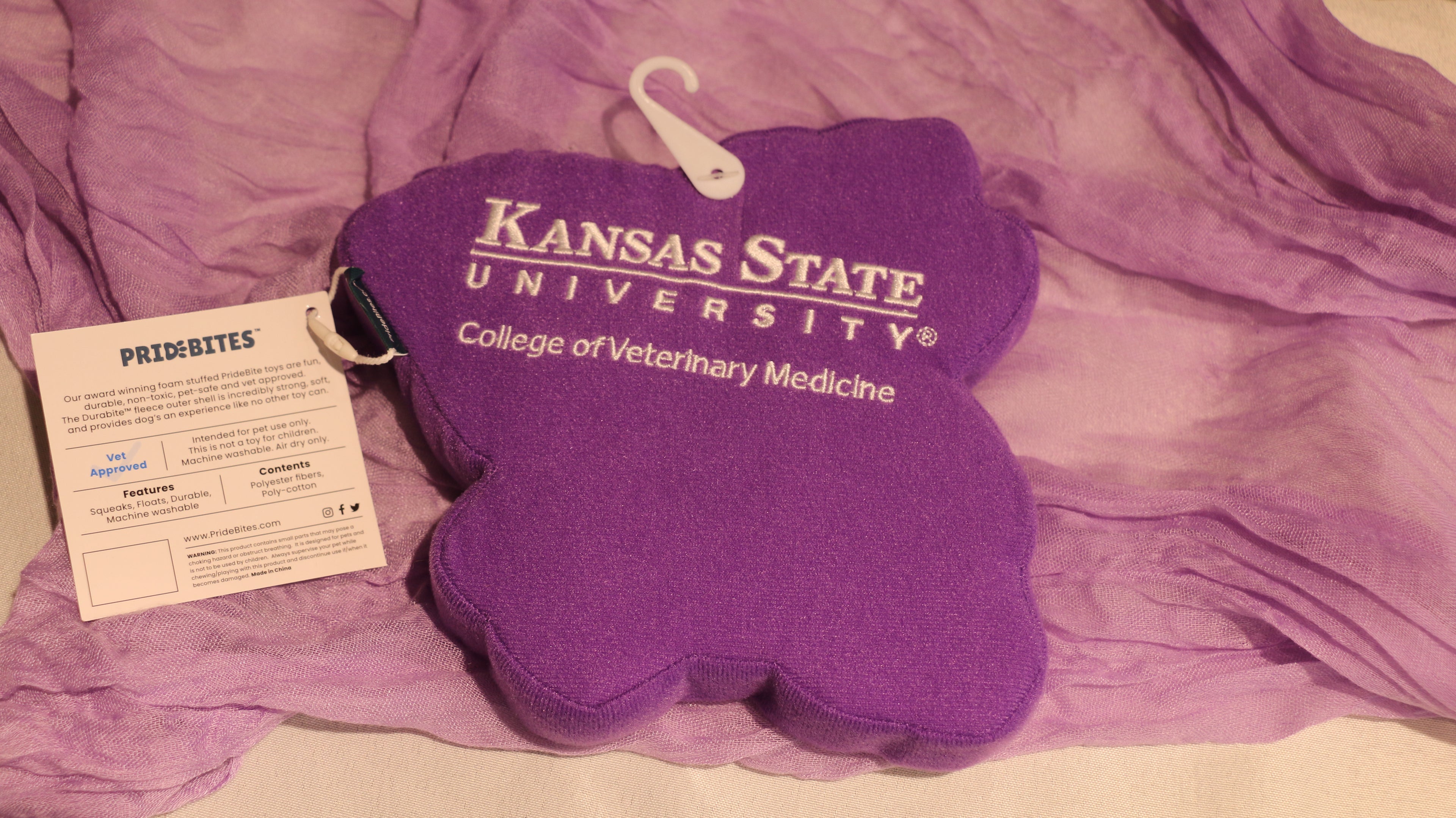 The back of the purple dog toy with white K-State CVM logo. 